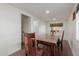 Dining area with a rustic wooden table, chairs, and ample natural light at 3622 W Sunland Ave, Phoenix, AZ 85041