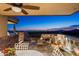 Covered back patio with fire pit, seating area, and stunning sunset views at 40070 N 111Th Pl, Scottsdale, AZ 85262