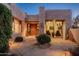 Evening view of the home's exterior elevation with a welcoming entryway and warm lighting at 40070 N 111Th Pl, Scottsdale, AZ 85262