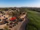 Aerial view of a home with a fire pit area adjacent to a golf course at 40070 N 111Th Pl, Scottsdale, AZ 85262