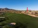 Golf course with a home nestled against a backdrop of mountains at 40070 N 111Th Pl, Scottsdale, AZ 85262