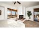 Main bedroom with fireplace, balcony access, and large windows offering scenic views at 40070 N 111Th Pl, Scottsdale, AZ 85262