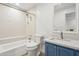 Updated bathroom with blue vanity, white tub, and modern fixtures at 5200 S Lakeshore Dr # 204, Tempe, AZ 85283