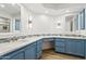 Spacious bathroom with blue cabinets, dual vanities, and modern fixtures at 5200 S Lakeshore Dr # 204, Tempe, AZ 85283