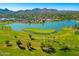 Aerial view of a golf course with a lake, homes, and mountain views at 7811 E Via De La Entrada --, Scottsdale, AZ 85258