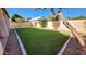 Private backyard with lush green artificial turf and a putting green at 846 W Kroll Ave, Gilbert, AZ 85233