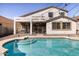 Inviting backyard with covered patio, sparkling pool, and string lights at 8775 W Lane Ave, Glendale, AZ 85305