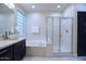 Modern bathroom with separate tub, glass shower, and dual vanities at 8775 W Lane Ave, Glendale, AZ 85305