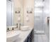 Modern bathroom with double sinks, glass shower, and white marble tile at 8775 W Lane Ave, Glendale, AZ 85305