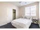 Inviting bedroom with white bedding, closet, and nightstand at 8775 W Lane Ave, Glendale, AZ 85305