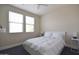 Bright bedroom with two windows, white bedding, and minimalist nightstands at 8775 W Lane Ave, Glendale, AZ 85305