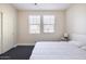 Spacious bedroom with two windows, closet, and carpeted flooring at 8775 W Lane Ave, Glendale, AZ 85305