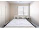 A simple bedroom with white bedding and minimalist decor at 8775 W Lane Ave, Glendale, AZ 85305