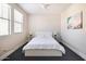 Simple bedroom with white bed, nightstands, and window blinds at 8775 W Lane Ave, Glendale, AZ 85305
