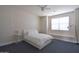 Cozy bedroom with white bedding, window seating, and minimalist decor at 8775 W Lane Ave, Glendale, AZ 85305