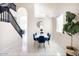 Elegant dining room with blue velvet chairs, white table, and stylish chandelier at 8775 W Lane Ave, Glendale, AZ 85305