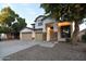 Charming two-story residence with a three-car garage, mature trees, and a welcoming entryway at 8775 W Lane Ave, Glendale, AZ 85305