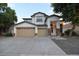 Inviting two-story home with a three-car garage and landscaped front yard at 8775 W Lane Ave, Glendale, AZ 85305