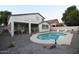 Two-story home with pool, gravel landscaping, and fenced backyard at 8775 W Lane Ave, Glendale, AZ 85305
