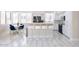 Bright kitchen with white cabinets, stainless steel appliances, and breakfast bar at 8775 W Lane Ave, Glendale, AZ 85305