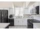 Modern kitchen with stainless steel appliances, white cabinets, and sleek countertops at 8775 W Lane Ave, Glendale, AZ 85305
