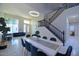 Spacious living area with high ceilings, elegant staircase, and modern dining table at 8775 W Lane Ave, Glendale, AZ 85305