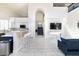 Open concept living room and kitchen with white tile, high ceilings and staircase at 8775 W Lane Ave, Glendale, AZ 85305