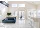 Living room with tile floor, large windows, a breakfast bar, and a view of the backyard pool at 8775 W Lane Ave, Glendale, AZ 85305