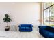 Living room with blue velvet furniture, large windows, and white tile floors at 8775 W Lane Ave, Glendale, AZ 85305