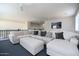Loft area with white sectional sofa, blue carpet, and wall art at 8775 W Lane Ave, Glendale, AZ 85305