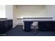 Home office or loft space with built-in desk and dark blue cabinets at 8775 W Lane Ave, Glendale, AZ 85305
