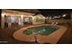 Inviting backyard pool at night, illuminated by string lights, creating a relaxing ambiance at 8775 W Lane Ave, Glendale, AZ 85305
