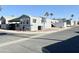 Corner lot location in a community with similar homes, visible mountains, and palm trees at 99 S Kaoline Dr, Apache Junction, AZ 85119
