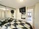 Bedroom featuring a bed, built-in shelving, TV, and mirrored closet at 99 S Kaoline Dr, Apache Junction, AZ 85119