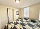 Cozy bedroom with a patterned bedspread, nightstand, and window with blinds at 99 S Kaoline Dr, Apache Junction, AZ 85119