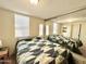 Bedroom with a bed, mirrored closet doors, and multiple windows at 99 S Kaoline Dr, Apache Junction, AZ 85119