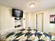 Bedroom with a bed, wall-mounted TV, and built-in storage at 99 S Kaoline Dr, Apache Junction, AZ 85119