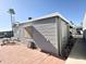 Exterior view of the home, highlighting the side with a patio area, table, chairs, and parked bicycles at 99 S Kaoline Dr, Apache Junction, AZ 85119