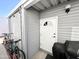 Exterior view of the home's side, showcasing a white door, siding, and parked bicycles at 99 S Kaoline Dr, Apache Junction, AZ 85119