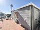 Side view of the home with a patio, table, chairs, and a glimpse of the neighboring properties at 99 S Kaoline Dr, Apache Junction, AZ 85119