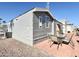 View of the home's exterior with a patio area, table, and chairs at 99 S Kaoline Dr, Apache Junction, AZ 85119
