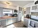 Kitchen with ample storage, a microwave, and sliding glass doors leading to a balcony at 99 S Kaoline Dr, Apache Junction, AZ 85119