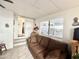 Living room with a sliding door, couch, window, and decorative items at 99 S Kaoline Dr, Apache Junction, AZ 85119