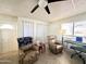 Living room with two recliners, a keyboard, and folding doors at 99 S Kaoline Dr, Apache Junction, AZ 85119