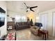 Living area with ceiling fan, brown couch, recliner, and holiday decor at 99 S Kaoline Dr, Apache Junction, AZ 85119