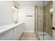 Stylish bathroom boasts a glass shower, gold fixtures, and white vanity at 1012 W Whitton Ave, Phoenix, AZ 85013