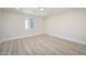 Bright bedroom with wood-look flooring and large window at 1012 W Whitton Ave, Phoenix, AZ 85013