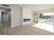 Bright living room with a modern fireplace and a green door leading to the front yard at 1012 W Whitton Ave, Phoenix, AZ 85013