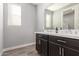 Elegant bathroom with double vanity and dark brown cabinets at 10157 E Texas Ave, Mesa, AZ 85212