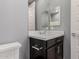 Modern bathroom with dark vanity and white countertop at 10157 E Texas Ave, Mesa, AZ 85212